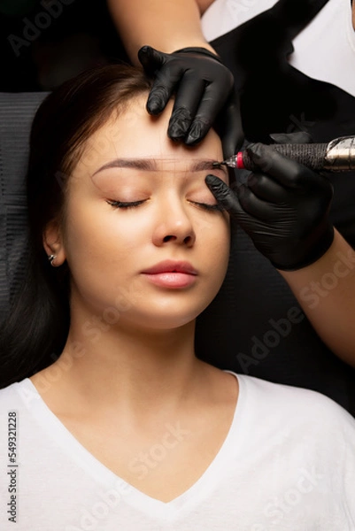 Fototapeta Beauty master applying permanent powder brow makeup