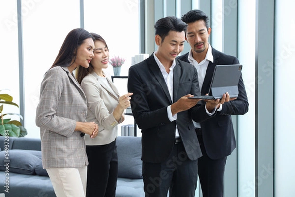 Obraz Business people stand relax meeting in office by using tablet and discussion or brainstorming