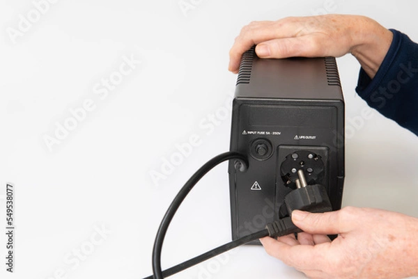 Fototapeta Conexión del cable de la computadora a la fuente de alimentación ininterrumpida