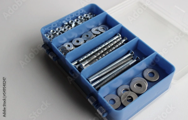 Fototapeta Opened Blue Set Box For Arranging Nuts, Bolts And Washers On White Surface Isolated
