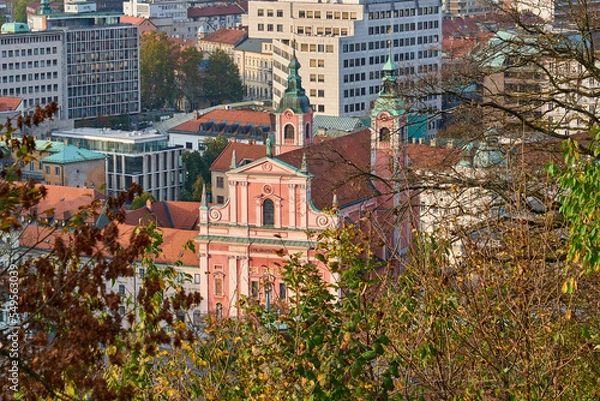 Fototapeta Detail of Franciscan Church of the Annunciation on city buildings background in Ljubljana, Slovenia, aerial view