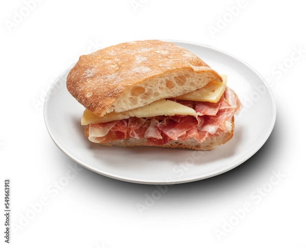 Fototapeta  Bocadillo de jamón serrano y queso curado sobre fondo blanco. Serrano ham and cured cheese sandwich on white background.