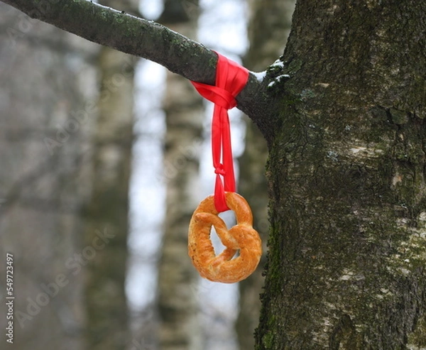 Obraz The pretzel is tied to a birch tree with a red ribbon