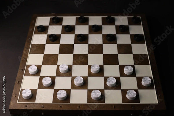 Fototapeta logical and educational checkers game for family and friends. white and black checkers on a brown board. for banners labels booklet splash screens