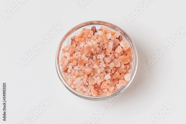 Fototapeta Top view of of a glass small bowl  with Himalayan coarse salt isolated  on white background
