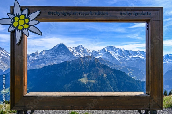 Fototapeta Wooden frame with a view on the mountain range Eiger Moench and Jungfrau in the Swiss alps