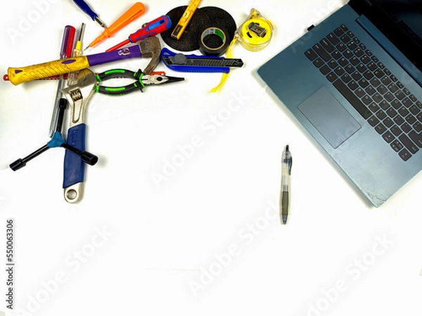 Fototapeta Flat lay, background mockup. The workspace on the desk background is white from the top view. layout room with laptop, handyman equipment and pencil on a white table background.