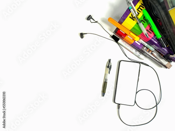 Fototapeta Flat lay,background mockup. the workspace in the background of the desk is white from the top view. layout space with mobile phones, books, pencils, stationery on a white desk background.