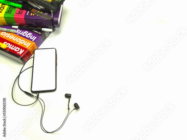 Fototapeta Flat lay,background mockup. the workspace in the background of the desk is white from the top view. layout space with mobile phones, books, pencils, stationery on a white desk background.