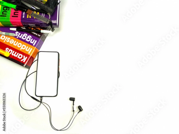 Fototapeta Flat lay,background mockup. the workspace in the background of the desk is white from the top view. layout space with mobile phones, books, pencils, stationery on a white desk background.