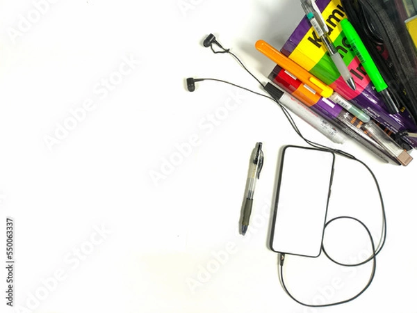 Fototapeta Flat lay,background mockup. the workspace in the background of the desk is white from the top view. layout space with mobile phones, books, pencils, stationery on a white desk background.
