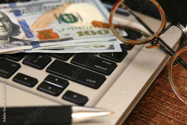 Fototapeta money, dollars, on computer keyboard