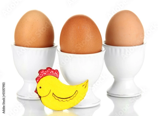 Obraz Whole boiled eggs in eggs cups isolated on white