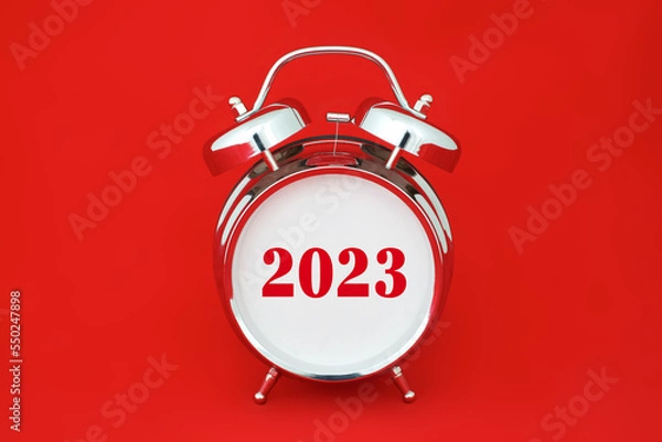 Fototapeta 2023 number on empty face of chrome retro alarm clock isolated on red background
