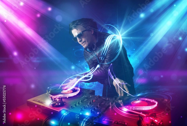 Obraz Energetic Dj mixing music with powerful light effects
