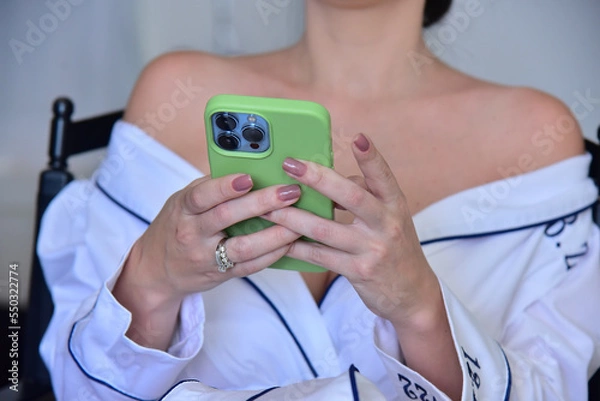Fototapeta bride in the making of looking at the cell phone
