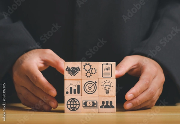 Fototapeta business strategy, Action plan, Goal and target, hand stack woods block step on table with icon about business strategy and Action plan. business development concept. copy space