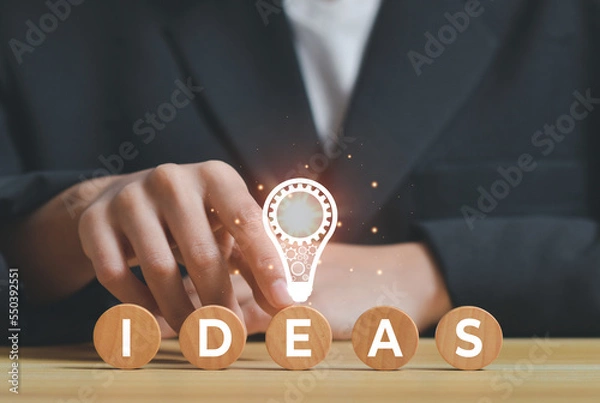 Fototapeta businessman with light bulb, Creative new idea. Innovation, brainstorming, inspiration and solution concepts with icon on wooden cube stack