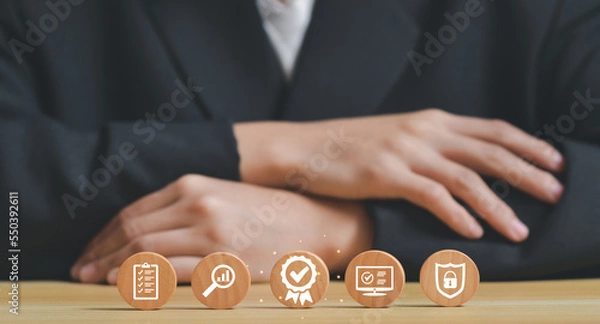 Fototapeta businessman behind the wood block circle with sign of the top service Quality assurance, Guarantee, Standards, ISO certification and standardization concept