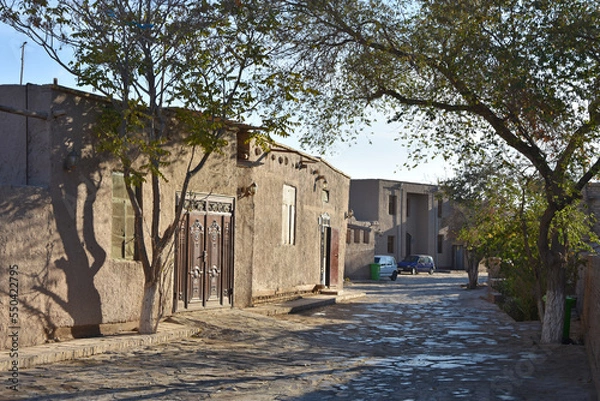 Fototapeta Old streets in oriental style of Khiva city in Uzbekistan with trees and houses