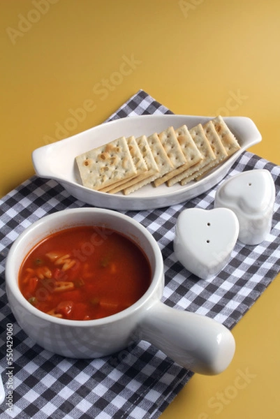 Obraz Alphabet soup served with saltine crackers, with space for text.
