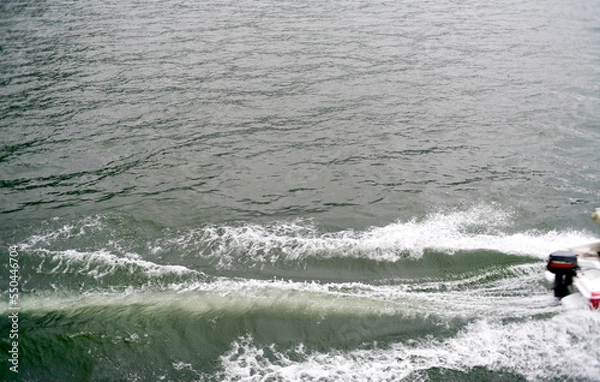 Fototapeta waves from a passing boat in lake. Stern wave from speed boat. Side view