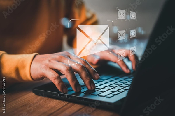 Obraz Freelancer's hand using computer laptop and sending online message with email icon, email marketing concept, send email or newsletter, internet network working online.