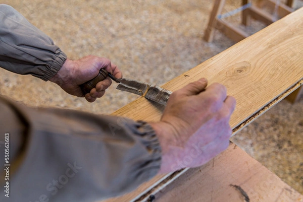 Obraz carpenter using grinder on wood