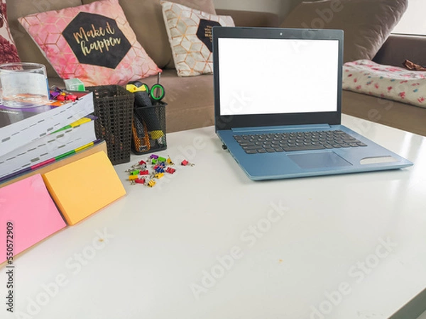 Obraz mockup image, laptop computer with blank screen in modern home room. with white space layout on a white table