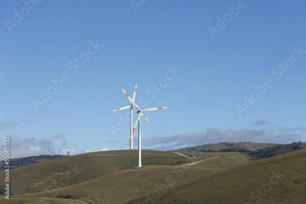 Fototapeta a wind farm full of turbines in the Italian mountains. The green economy and technology are the only solution to protect the planet from climate change and global warming