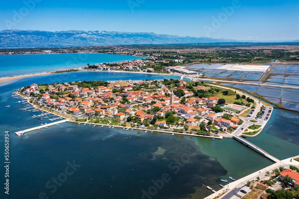 Fototapeta Historic town of Nin laguna aerial view with Velebit mountain background, Dalmatia region of Croatia. Aerial view of the famous Nin lagoon and medieval in Croatia