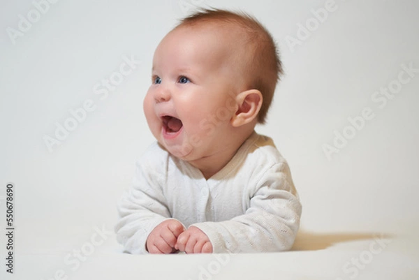 Fototapeta portrait of a smiling baby on a white background