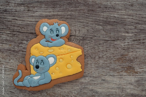 Fototapeta Cookies with mouse pattern with icing on a wooden table