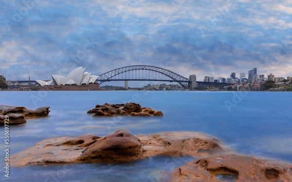 Fototapeta Sydney Harbour Australia at Sunset with the turquoise colours of the bay and high rise offices of the City in the background