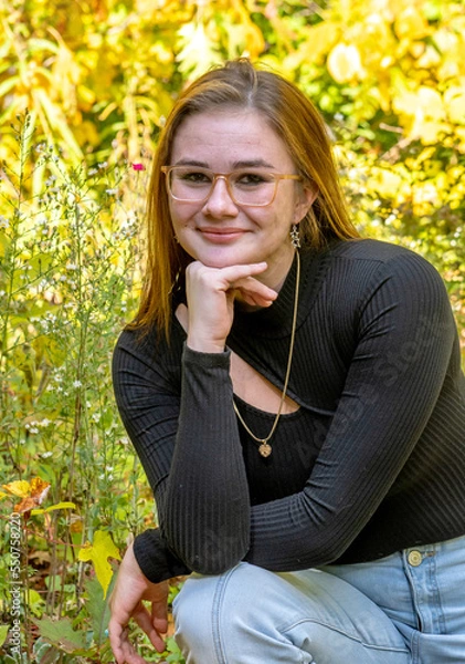 Obraz Pretty girl poses for s senior portrait on a fall day