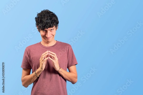 Obraz Young man with evil and funny face on flat lay.