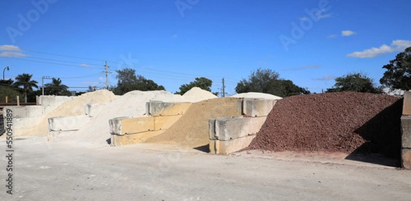 Fototapeta Large quantities of different landscaping rocks, stones, sand and fill for sale at a local supply shop. 