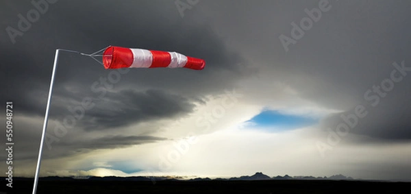 Fototapeta Windbag in huge storm and dark silhouetted mountains. Concept for creative business ideas. Iceland.