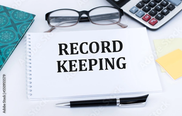 Fototapeta RECORD KEEPING text written on paper folder and charts