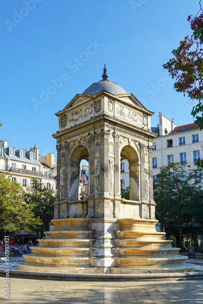 Fototapeta Paris, France - Fontaine des Innocents, a public fountain on the place Joachim-du-Bellay in the Les Halles district in the 1st arrondissement of Paris.  Image has copy space.