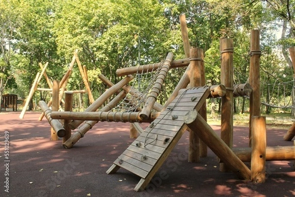 Obraz Wooden modern ecological safety children outdoor playground equipment in public park. Nature architecture construction playhouse in city. Children rest and childhood concept. Idea for games on air.