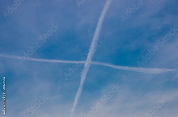 Fototapeta A cross in the sky made by the tracks of some planes