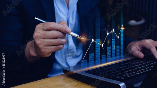 Fototapeta Businessman stylus pen touch points symbol stock graph and chart background, concept growth and development business investment, Stock market and strategy making market plan 