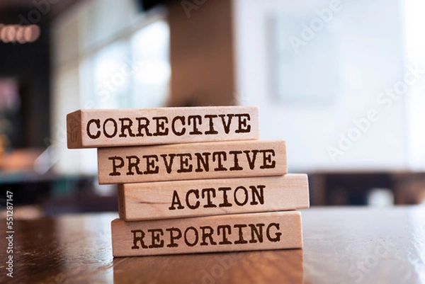 Fototapeta Wooden blocks with words 'Corrective Preventive Action Reporting'.