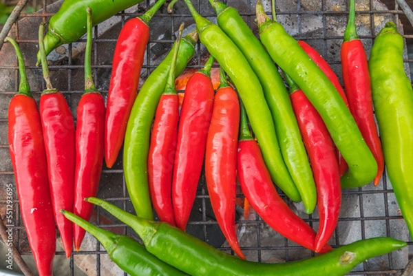 Obraz Red and green chili grill on stove for prepare a cook of spicy food. Food and vegetable background