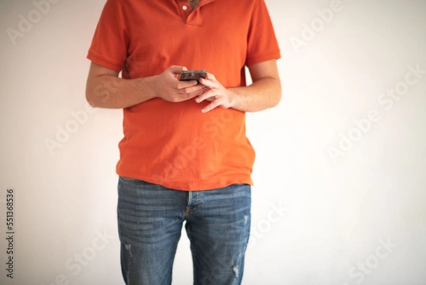 Obraz Man typing something in the smartphone