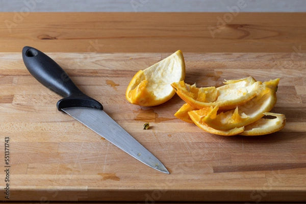 Fototapeta Sliced and eaten orange with a knife