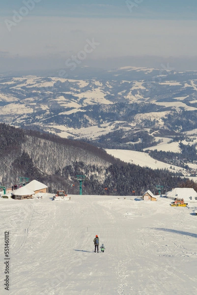 Obraz Ski resort in Ukrainian mountain landscape photo. Beautiful nature scenery photography with mom and kid on background. Idyllic scene. High quality picture for wallpaper, travel blog, magazine, article