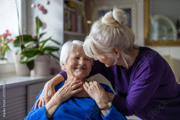 Obraz Woman hugging her elderly mother

