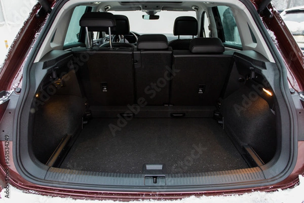 Fototapeta Huge, clean and empty car trunk in interior of compact suv. Rear view of a SUV car with open trunk